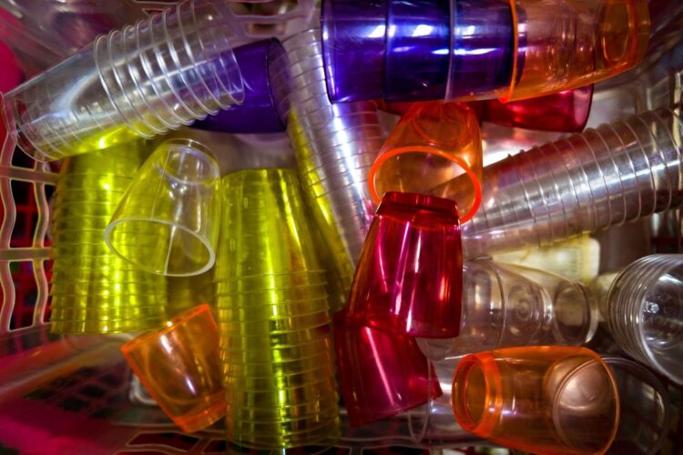 Brightly colored reusable plastic cups piled together