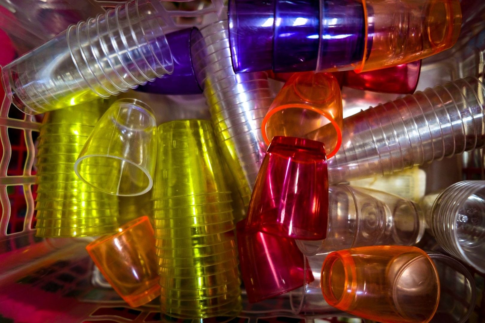 Brightly colored reusable plastic cups piled together