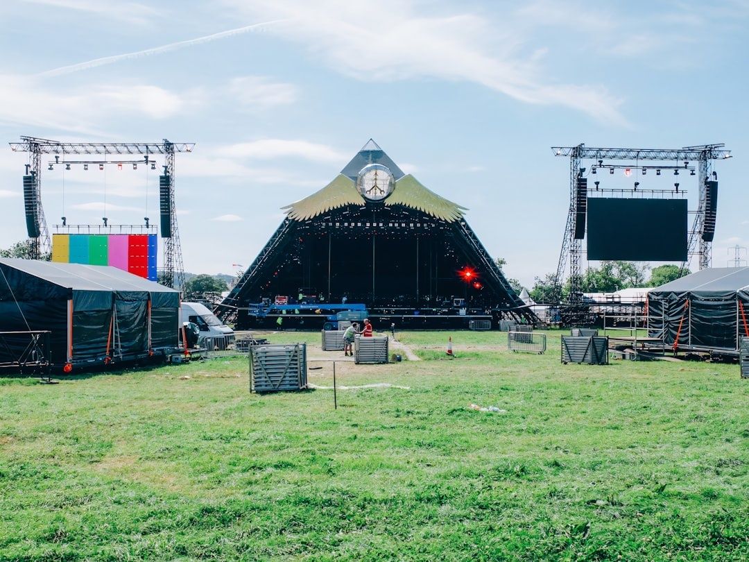 Outdoor festival stage with suspended speakers and lighting rigs